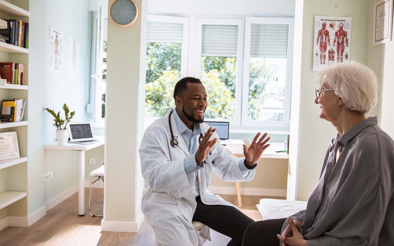 A doctor speaking with an elder patient