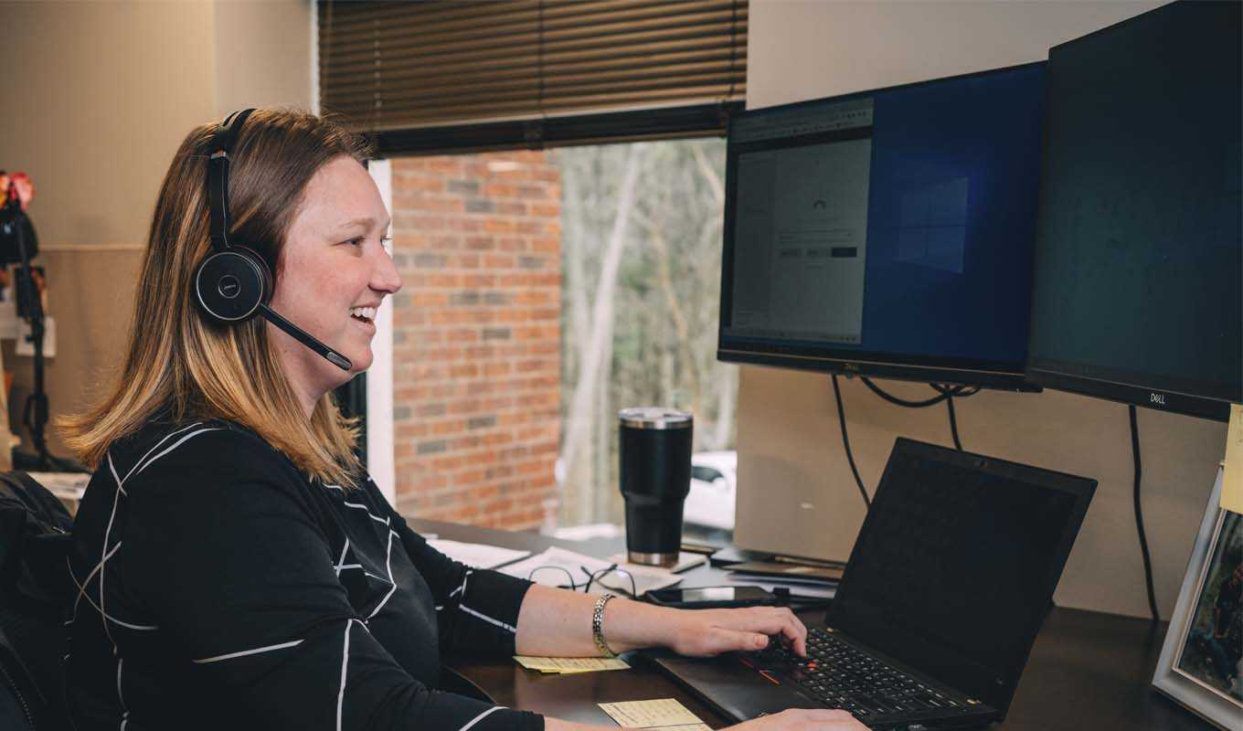 Samaritan Ministries employee working at her desk