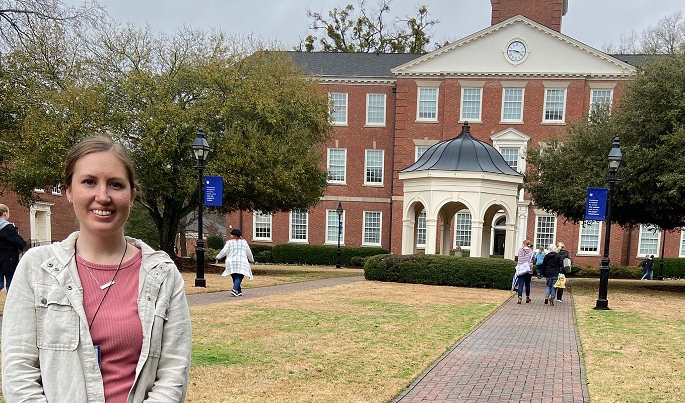 Young woman stands on college campus