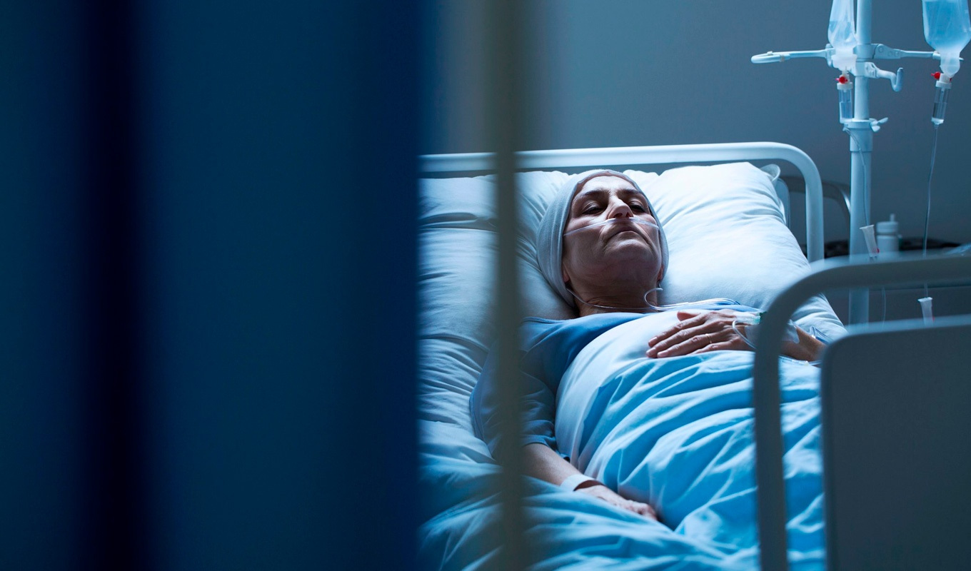 A very ill patient on a hospital bed