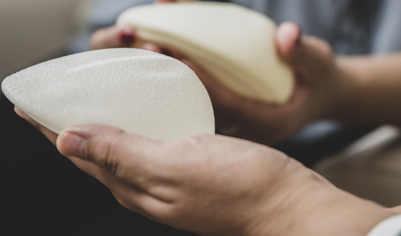 Doctor holding breast implants