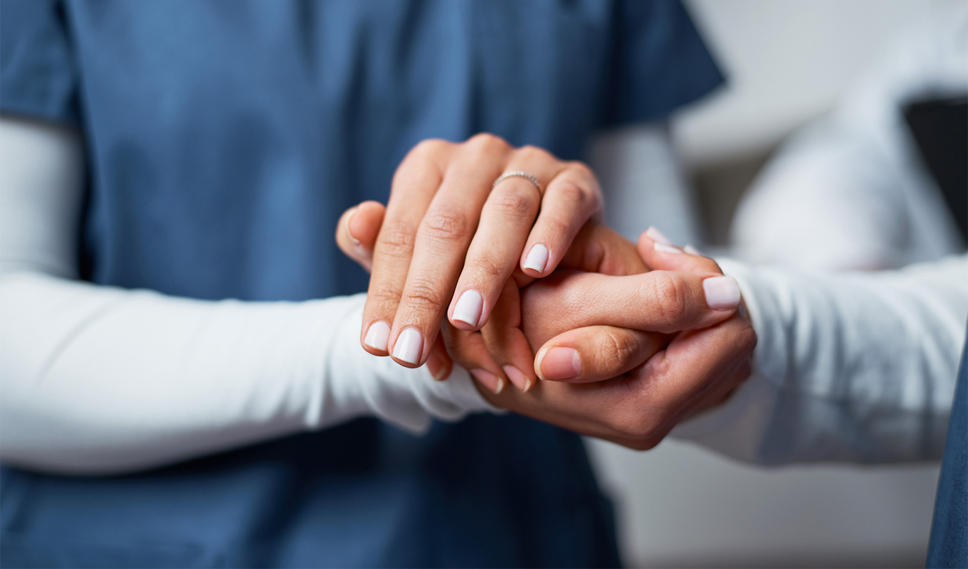 Close-up of one person gently holding another’s hands, symbolizing Christian encouragement, care, and supportive Gospel ministry in action.