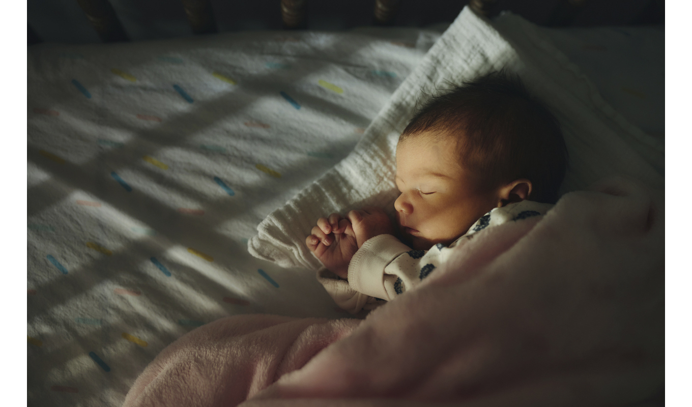 Infant asleep in a crib