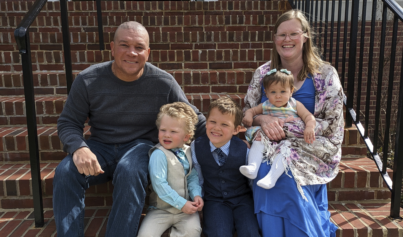A family smiling on church steps, capturing a moment of togetherness and joy.