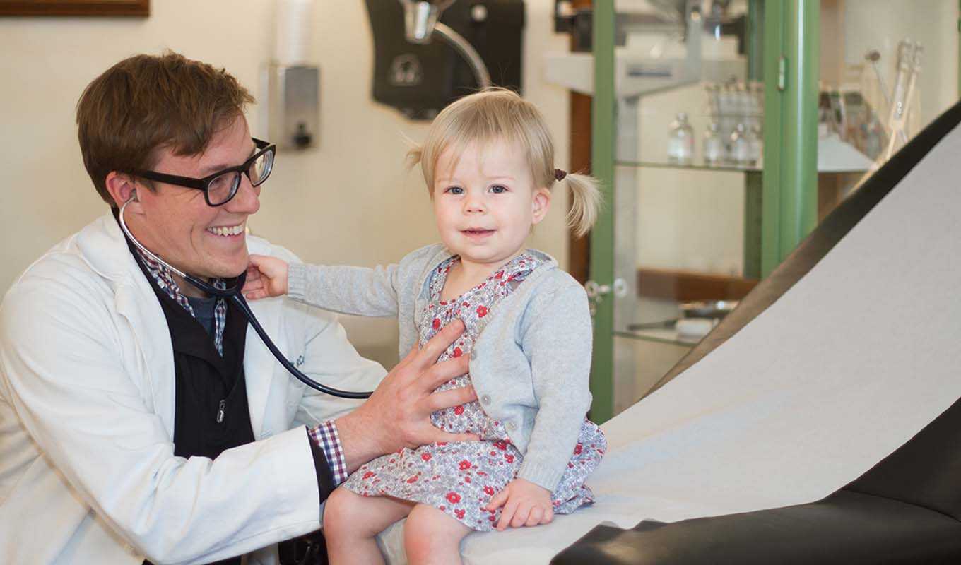 Doctor examining a toddler