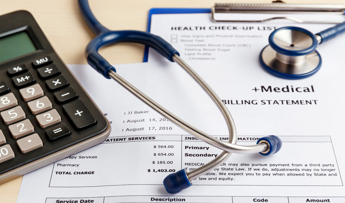 Medical billing statement with itemized charges and total cost, stethoscope and calculator on desk.
