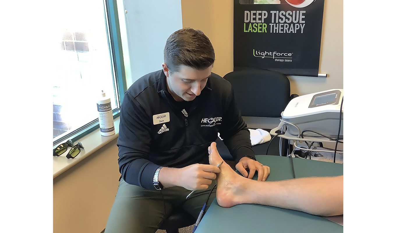 A therapist at Hecker Sports and Regenerative Medicine treats a patient’s foot.
