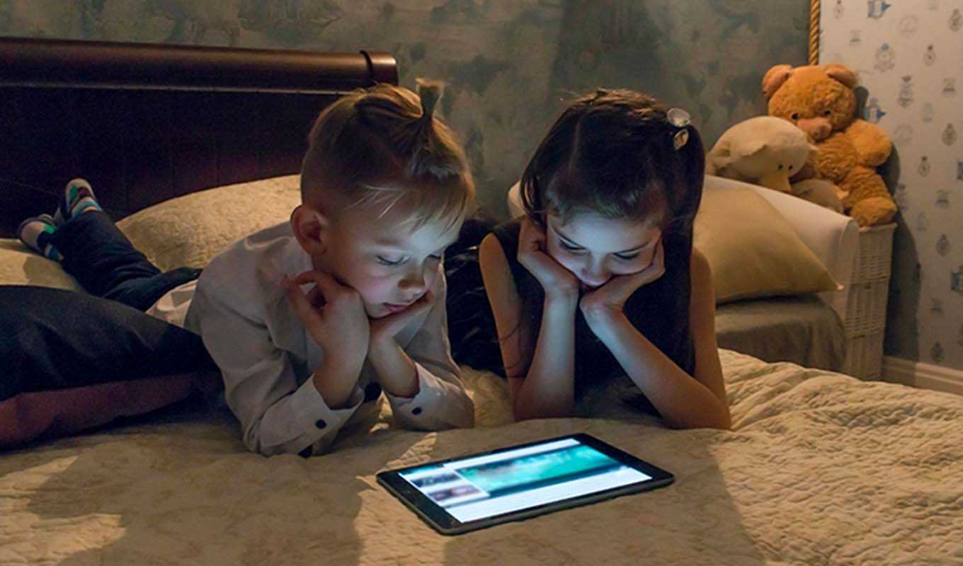 Brother and sister looking at a tablet computer