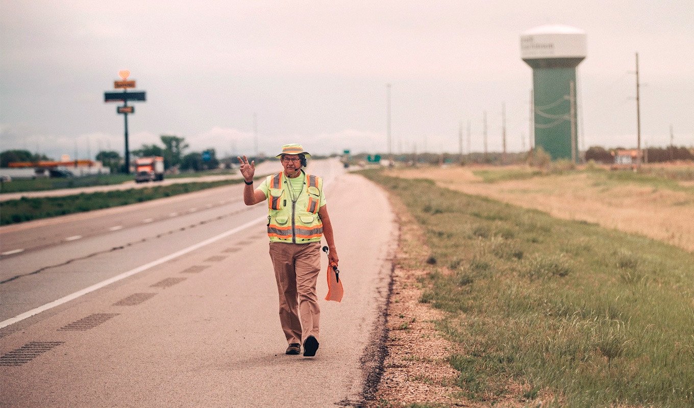 Glenn Koster walking down a highway