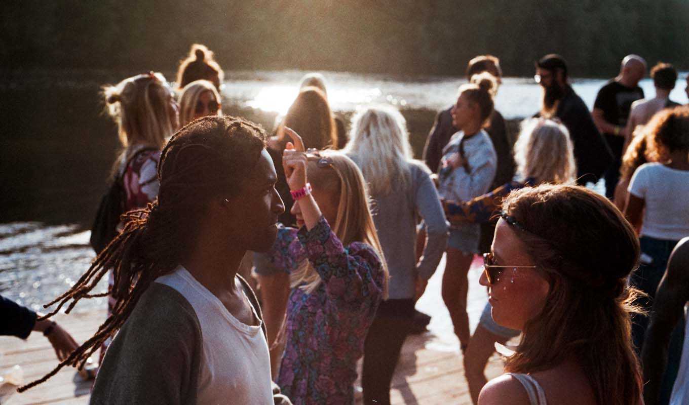 Large group of people gathered together by water