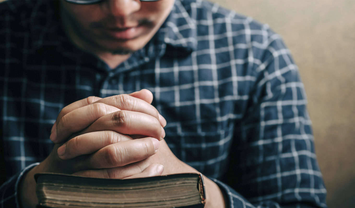 Man praying with his Bible