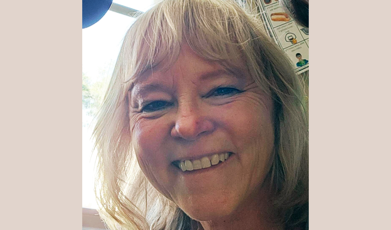 Close-up portrait of a Samaritan member testimonial participant with a relaxed, teeth-showing expression, illustrating positive healthcare concierge experience, patient satisfaction, and medical cost savings with Valenz Bluebook services.