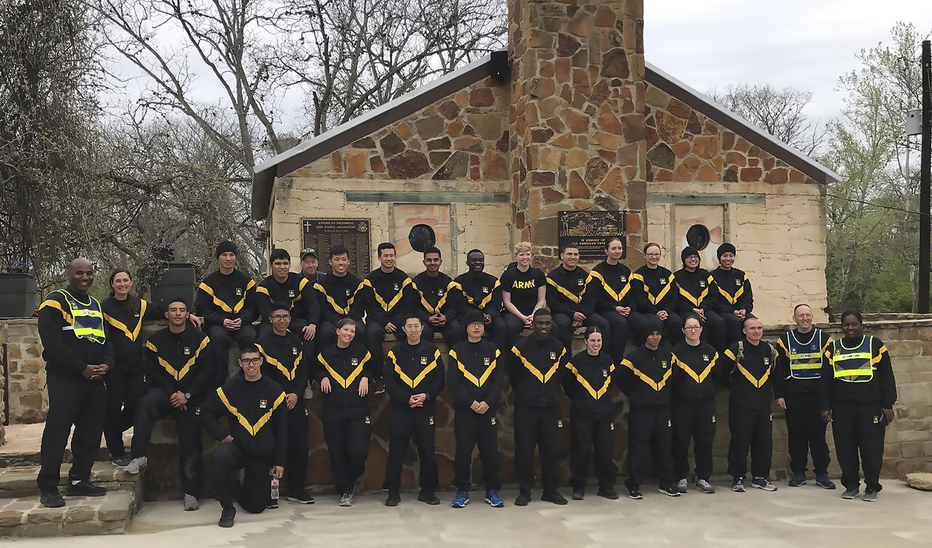 An Army group stands in front of the SS American Memorial building at the Lazy-U Ranch near Seguin, Texas.
