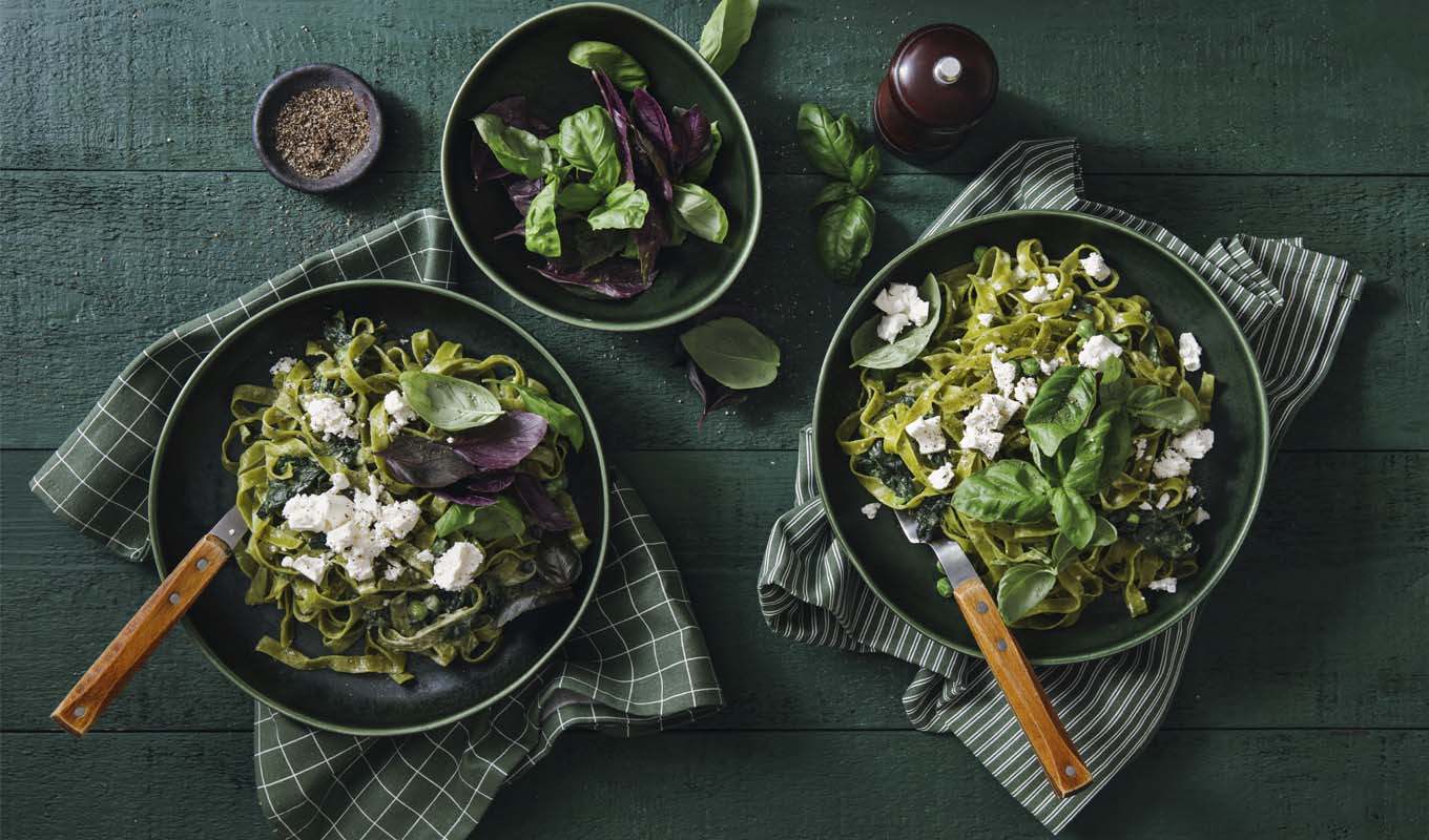 Three salads of different sizes on a dining room table